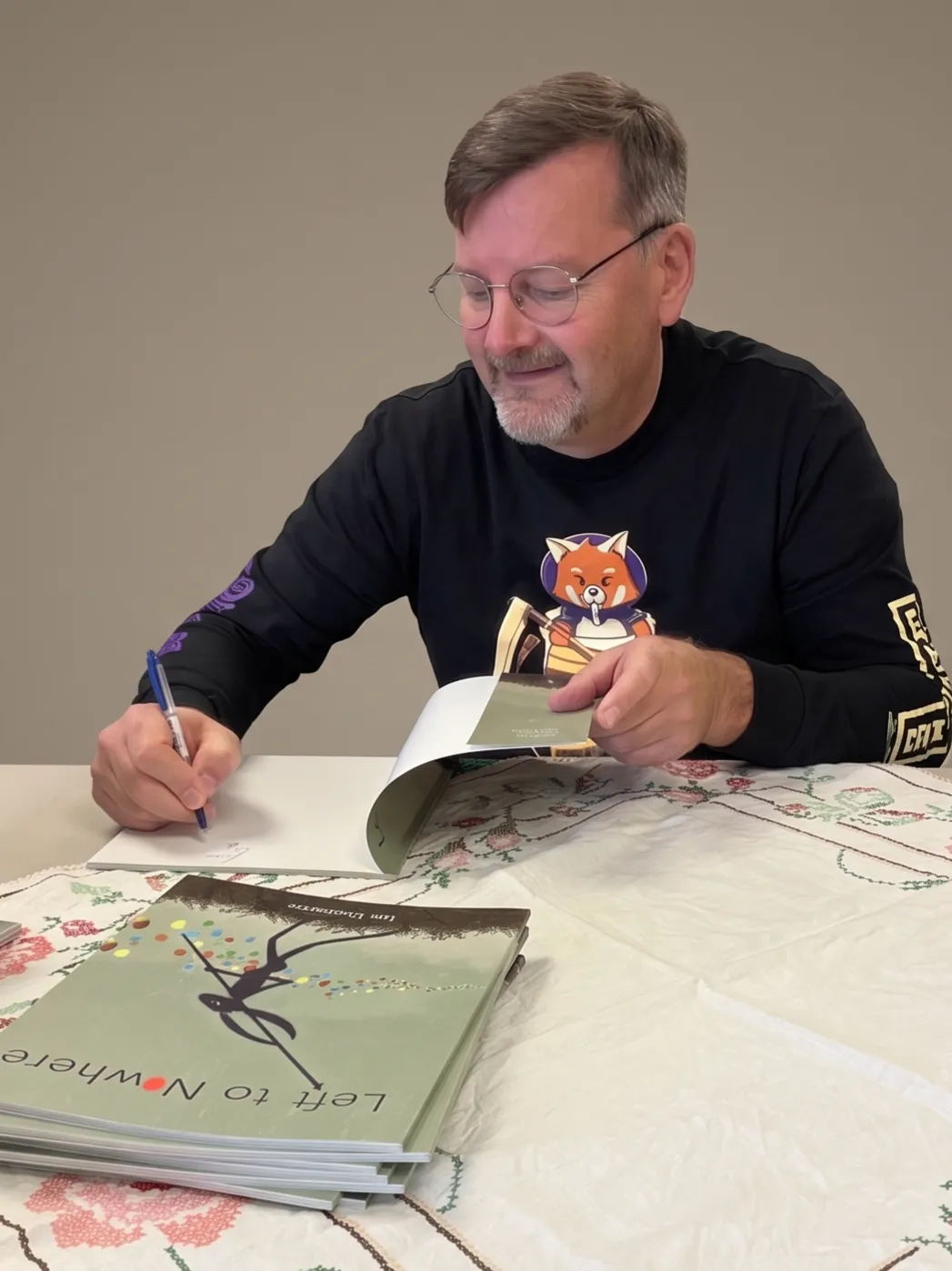 Image of Ian Chapman signing books